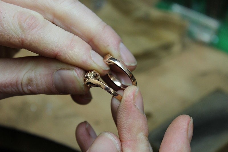 an uncleaned raw engagement ring made from rose gold