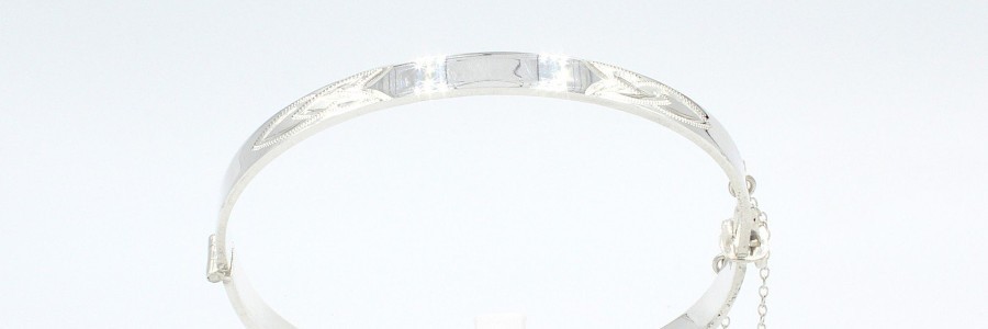 a silver solid metal bangle on a white background