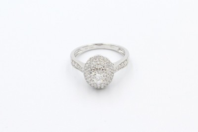 a white gold halo engagement ringw ith one large oval shaped diamond ona  white background