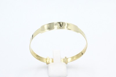 a gold baby bangle with an engraving plaque