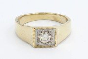an inlay setting on a mans golden ring