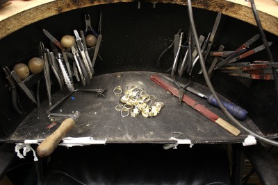 a jewellery repair bench/desk with various tools on it