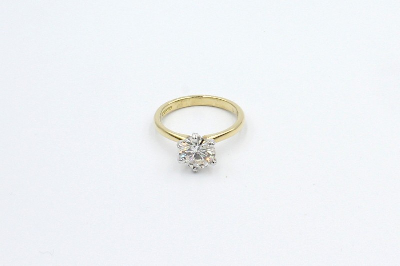 a gold ring with a large solitaire diamond