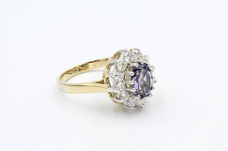 a gold oval sapphire ring with a diamond halo