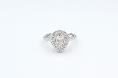 a double-halo pear shaped diamond engagement ring on a white background