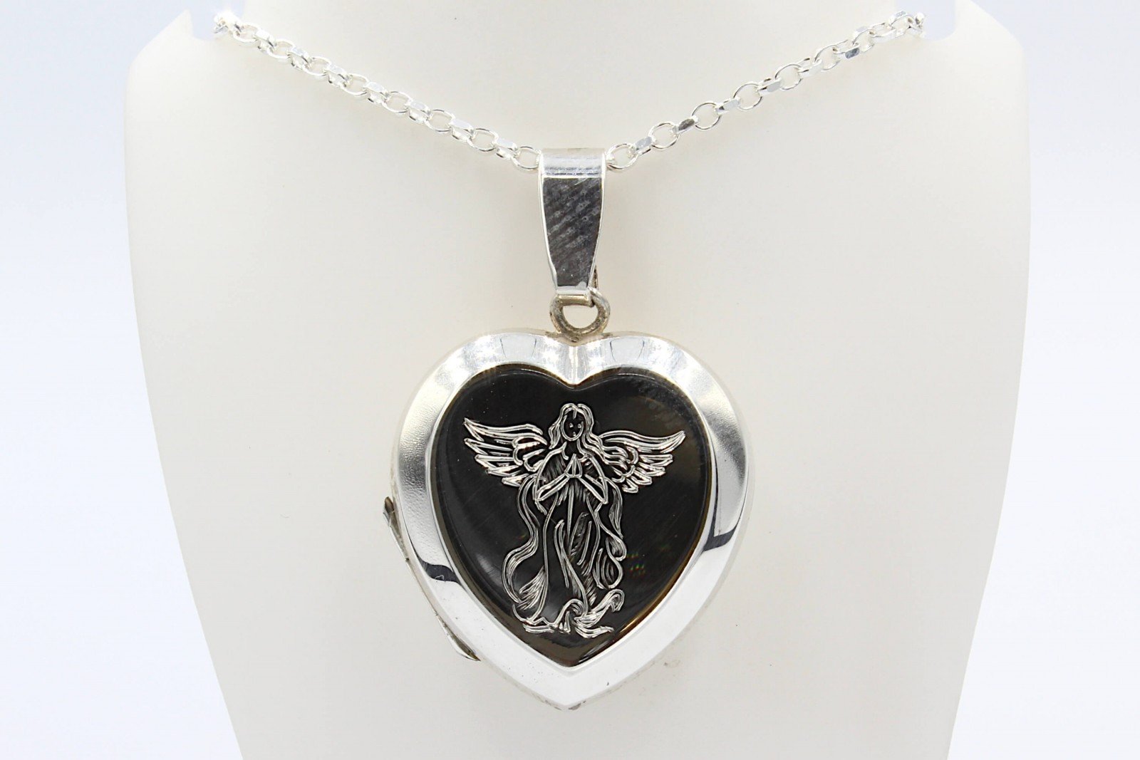 a siver cremation locket and chain engraved with an angel