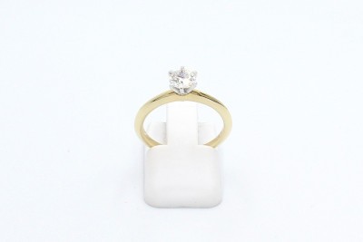 a tiffany style diamond solitaire engagement ring on a white background