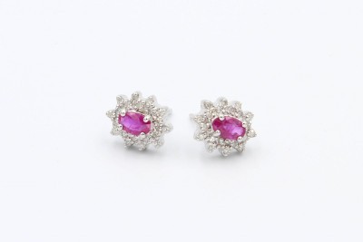 diamond and ruby stud earrings on a white background