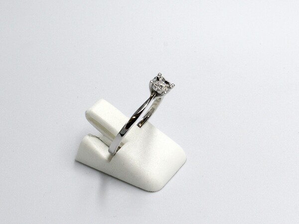 side view of a white gold diamond illusion set engagement ring