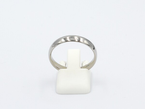 side view of a platinum wedding ring on a white background