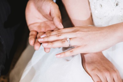 groom holding brides hand with ring on finger