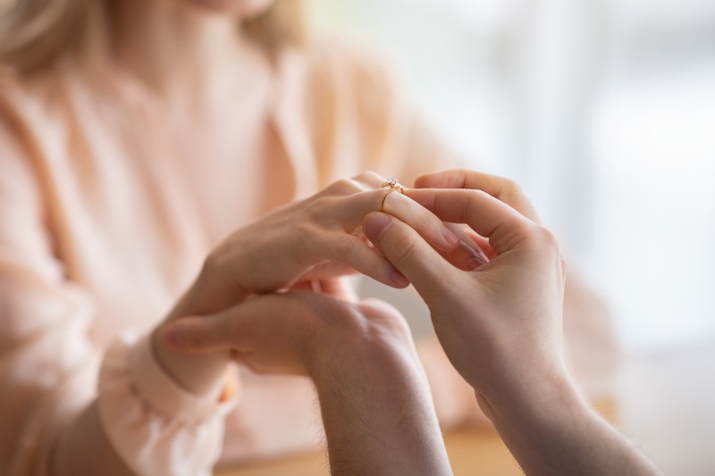 person putting a ring on a partner's finger