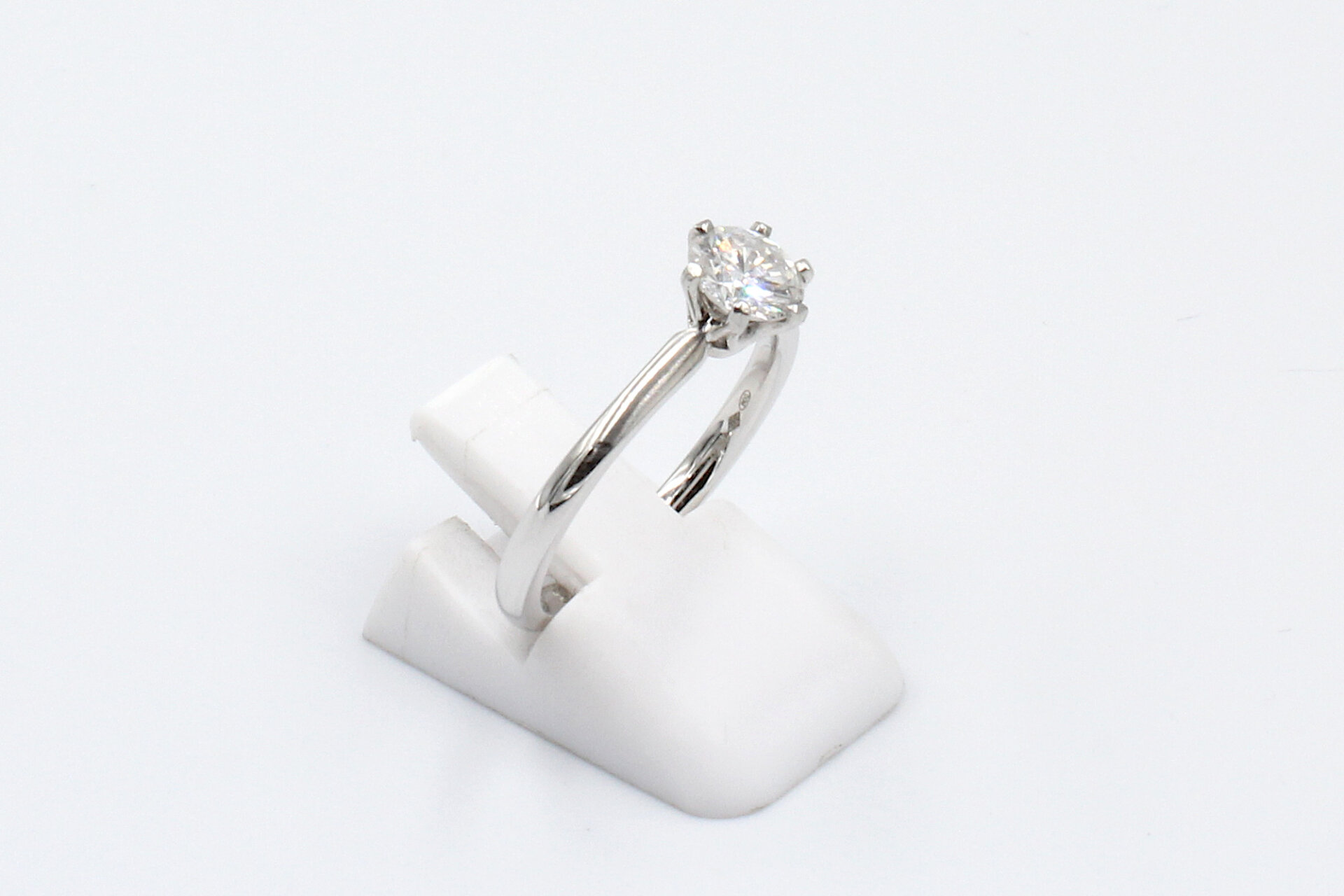 side view of a platinum and diamond engagement ring