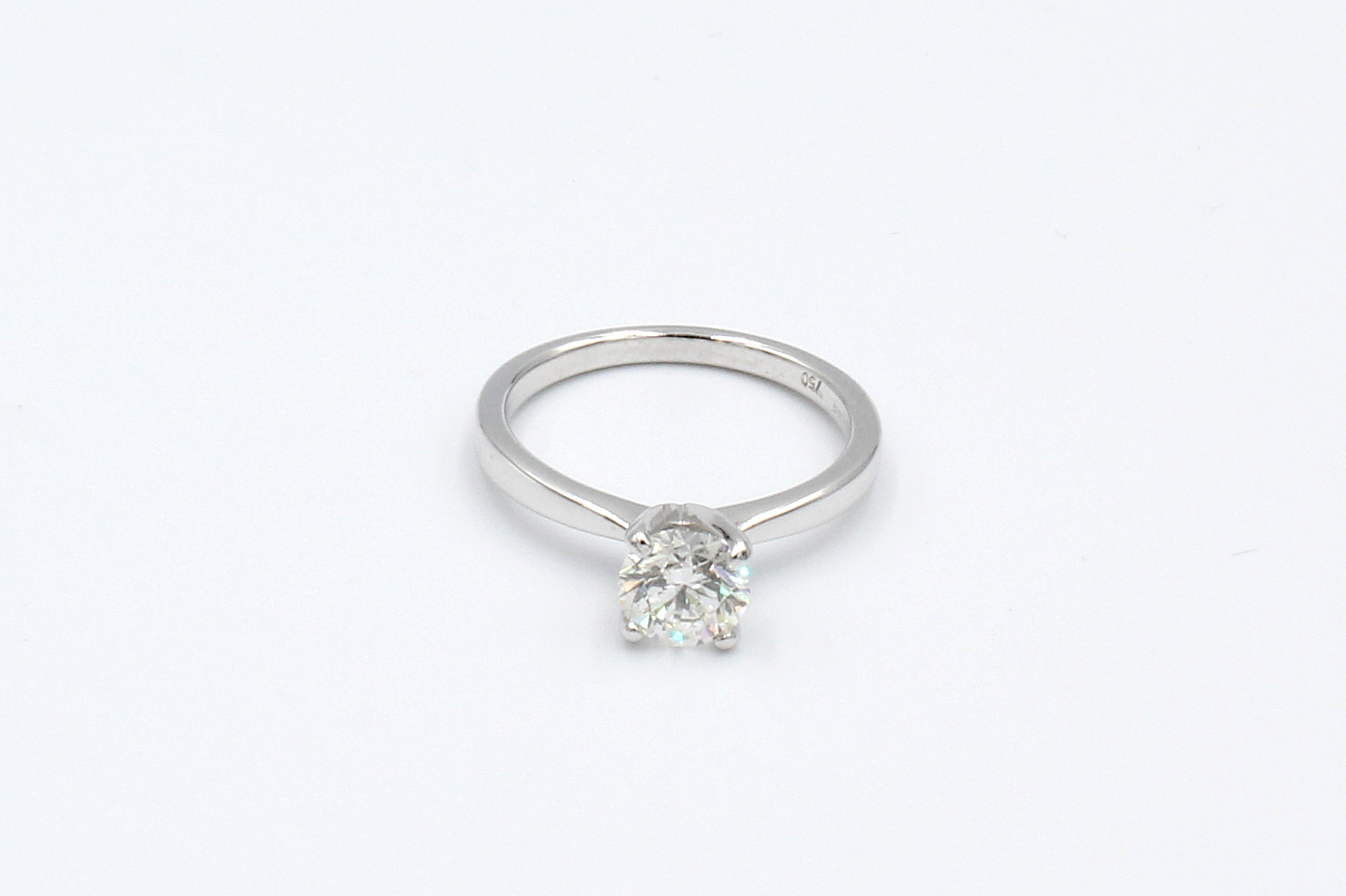 front view of a white gold solitaire diamond engagement ring