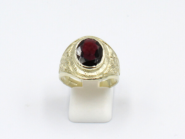 front view of a garnet and gold college ring