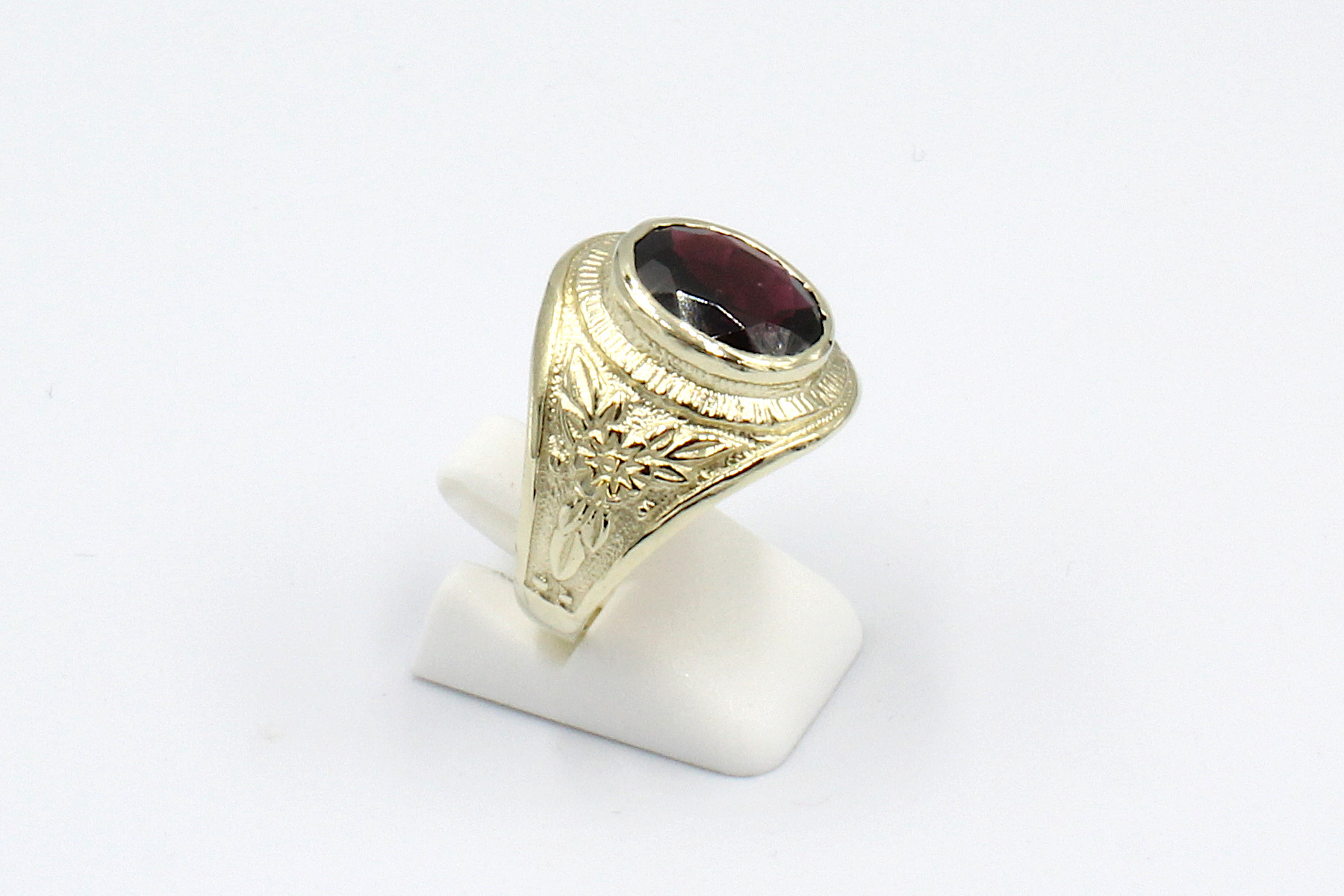 side view of a garnet and gold college ring