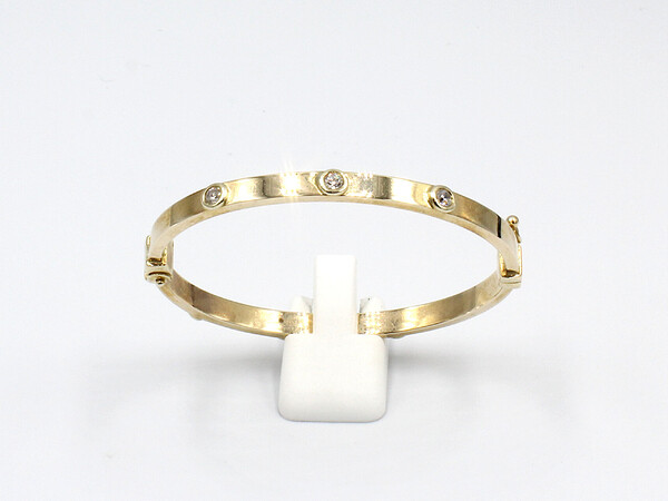 front view of a gold and cubic zirconia childs bangle