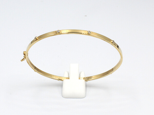 front view of a gold and cubic zirconia ladies bangle