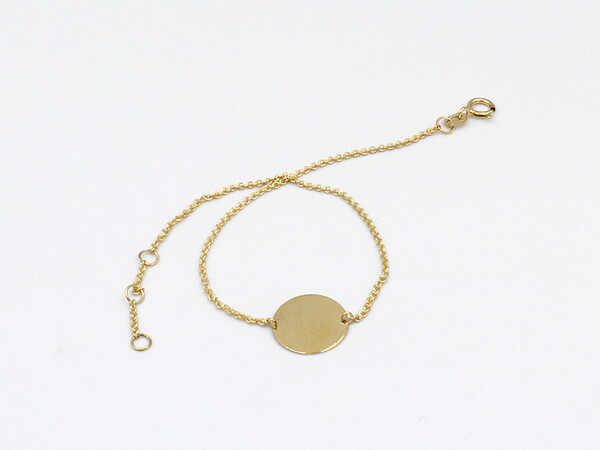 a gold bracelet with a blank id disk
