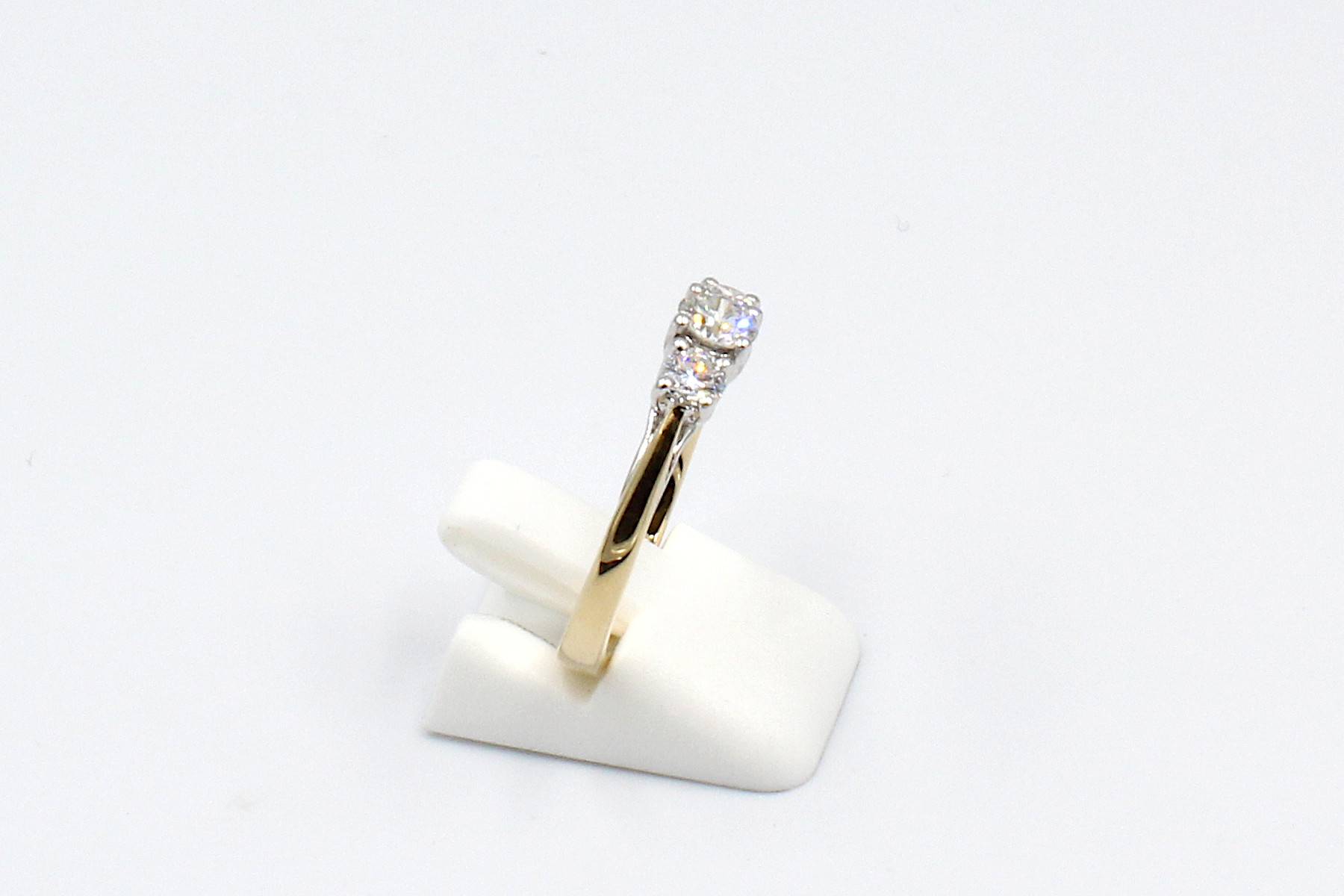 side view of a gold multi-diamond engagement ring