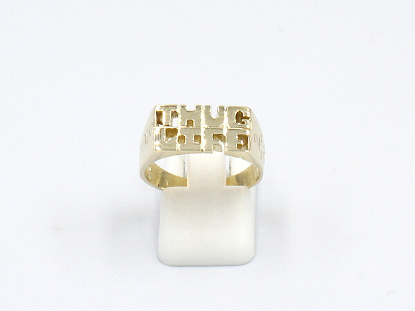 front view a ring made from gold thug life letters