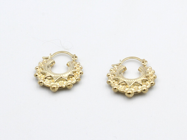 loose gold creole earrings on a white background