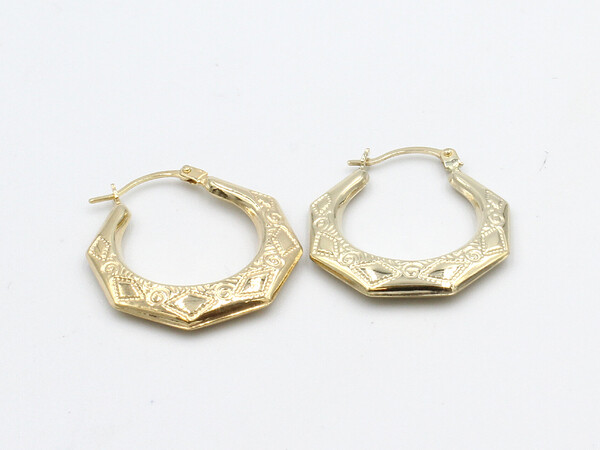a set of loose gold creole earrings