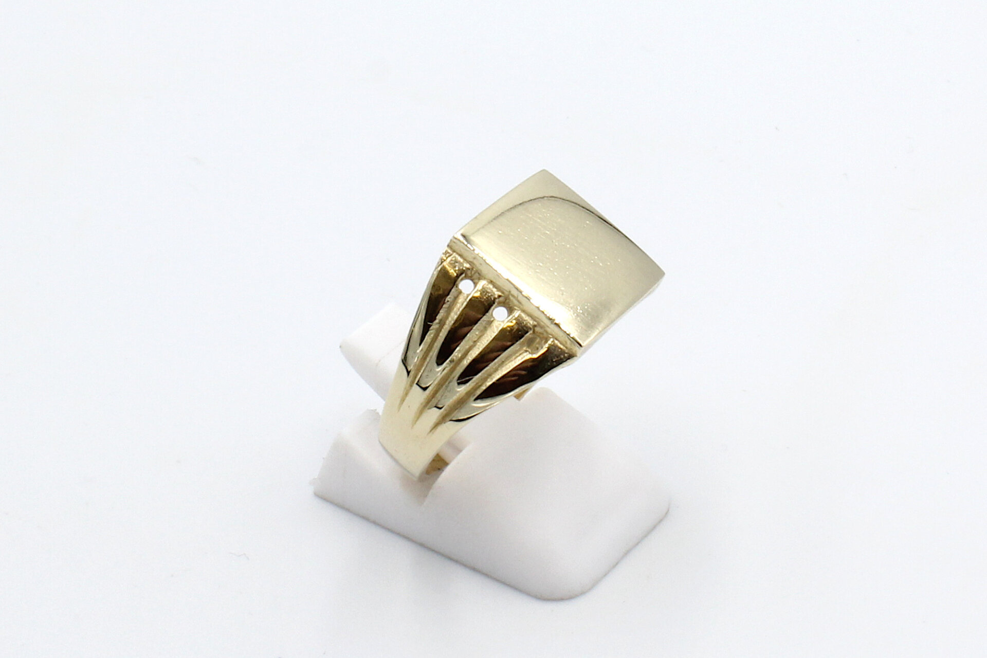 side view of a plain gold signet ring
