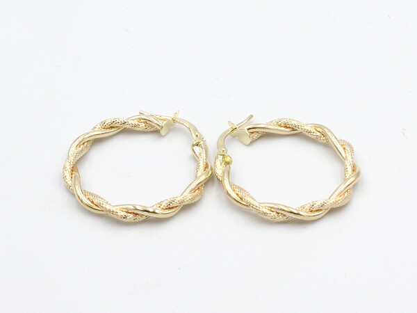 gold twisted hoop earrings on a white background