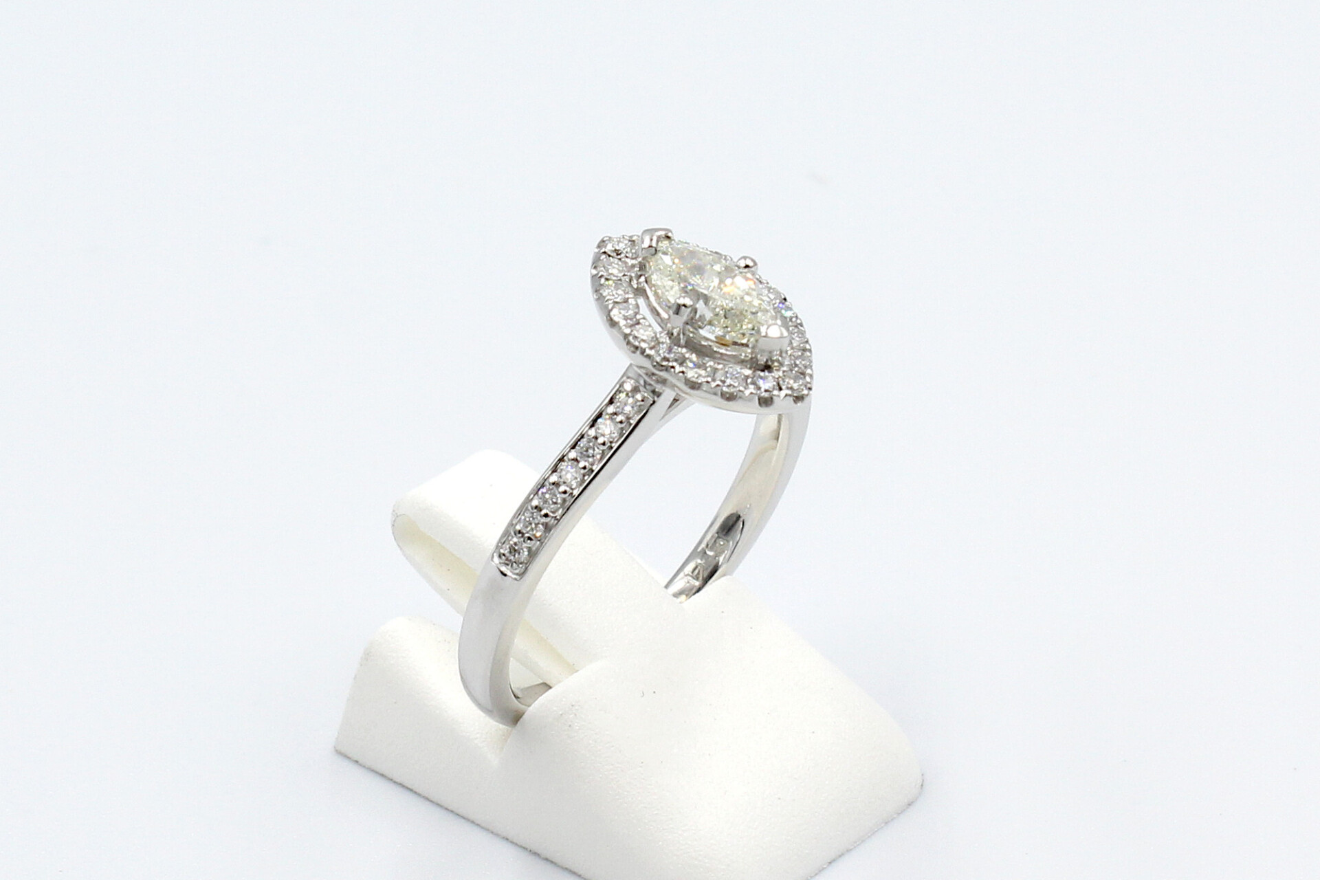 side view of a platinum and diamond halo engagement ring