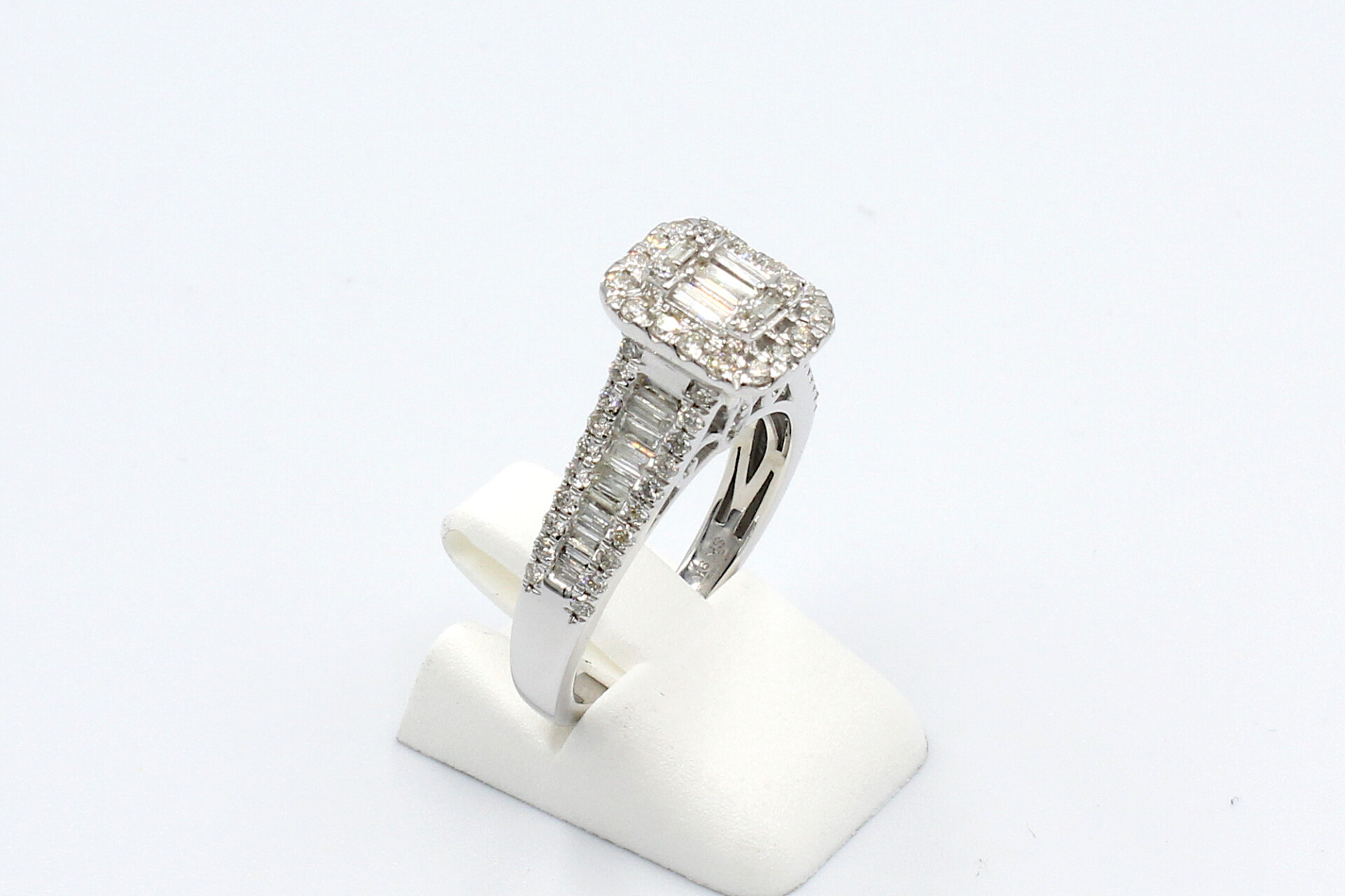 side view of a white gold and diamond halo engagement ring