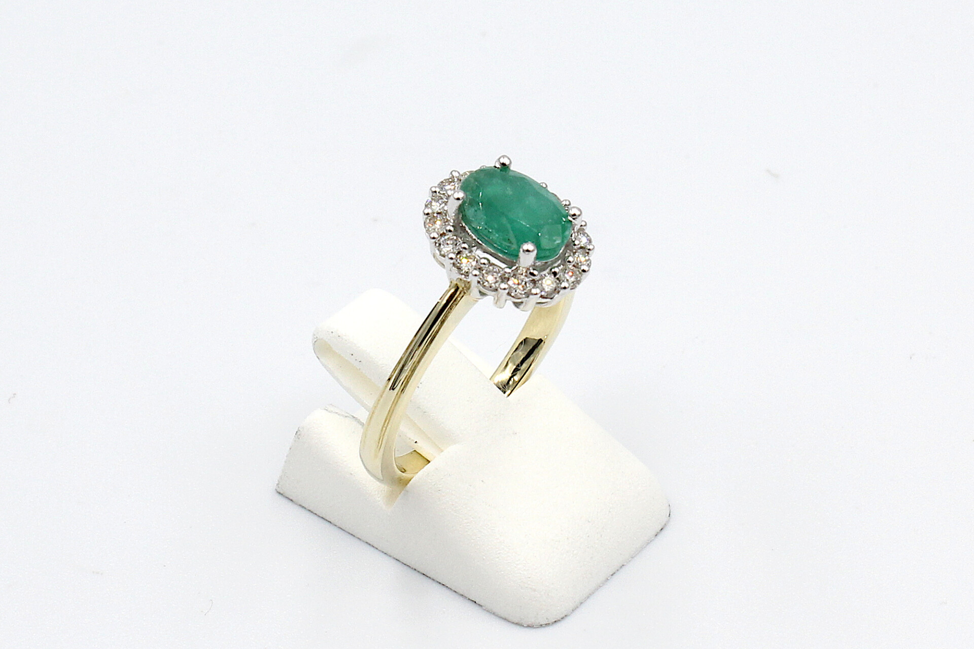 side view gold emerald diamond halo ring