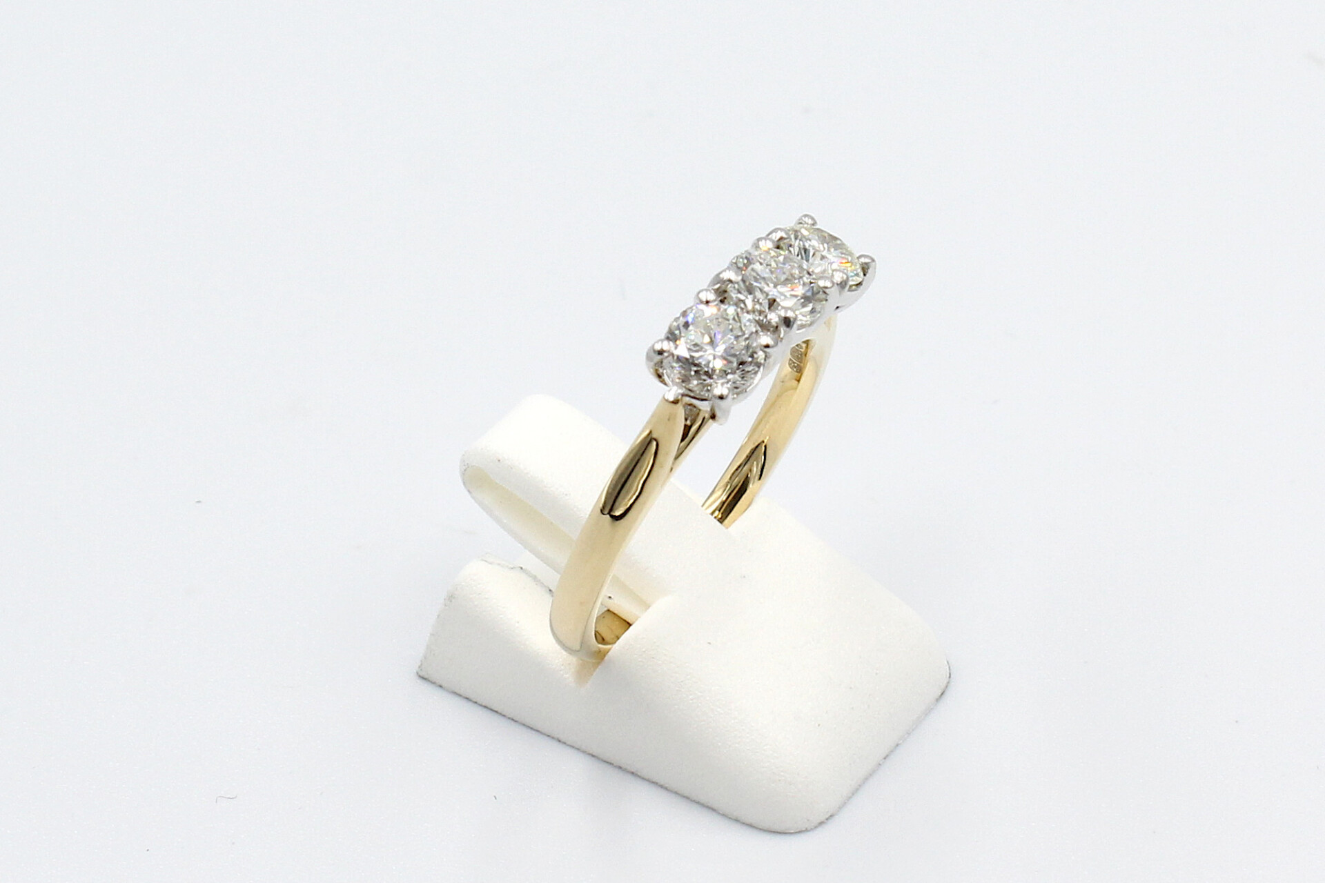 side view of a gold multi-diamond engagement ring