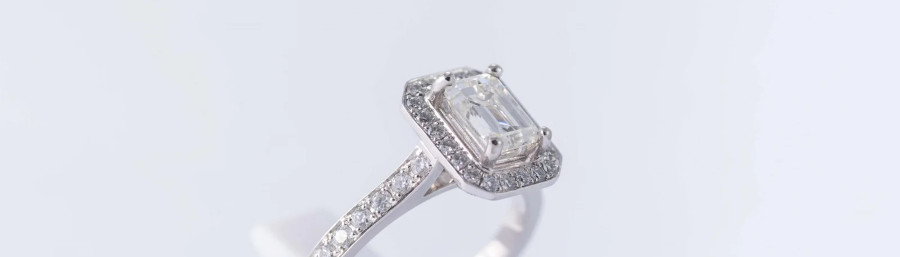 emeral cut diamond on a halo engagement ring