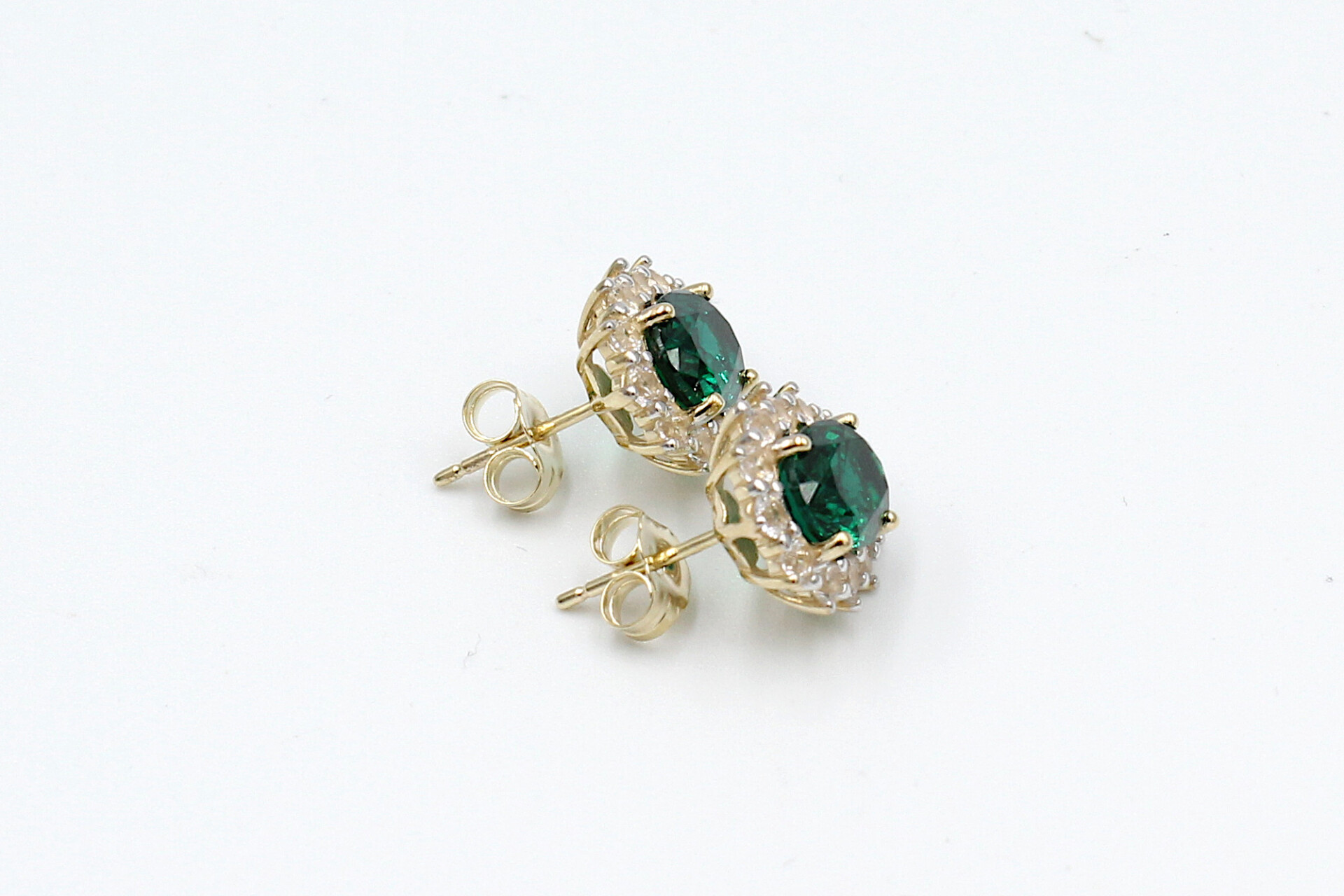 side view faux emerald halo stud earrings