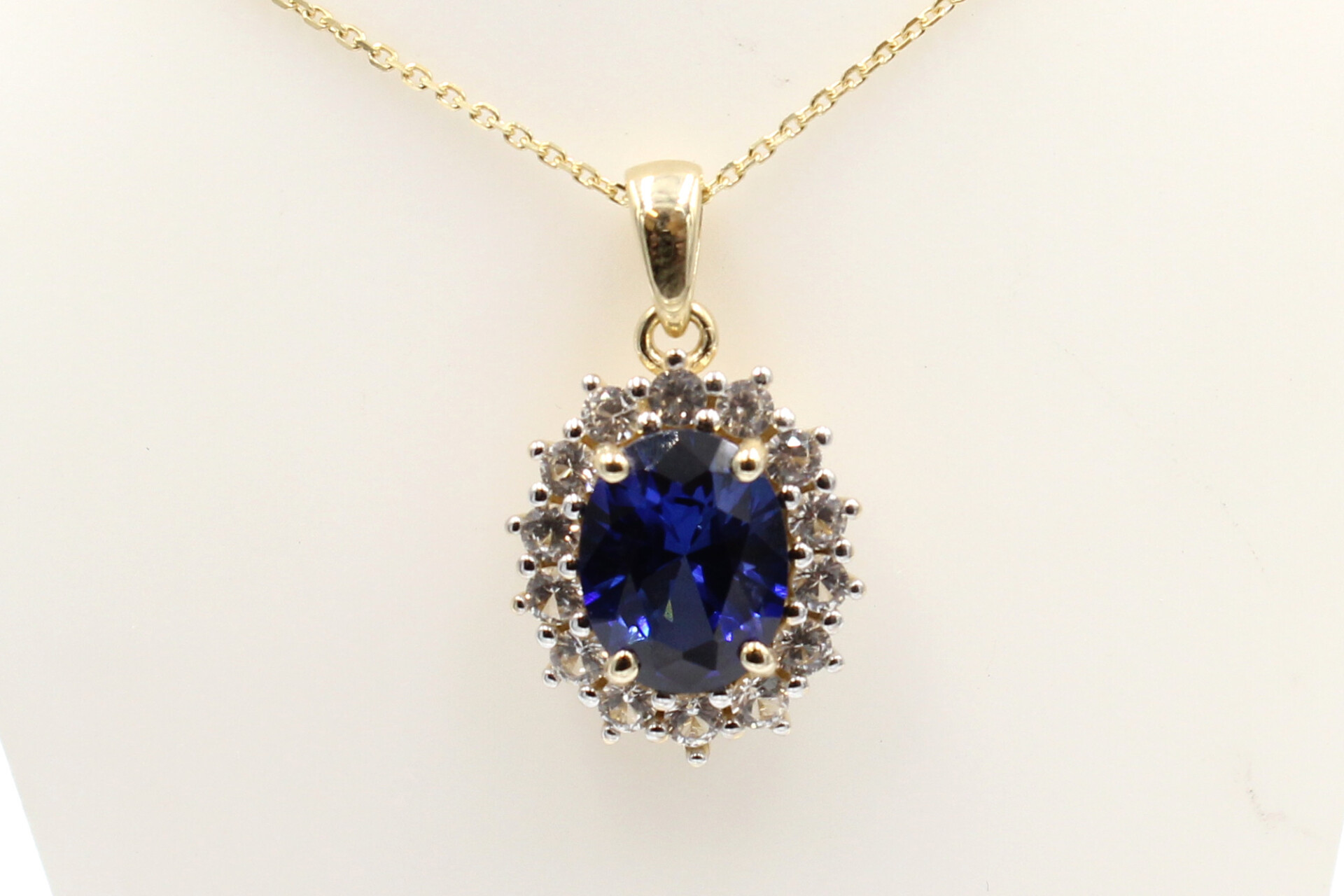 front view of a faux sapphire halo pendant on a chain