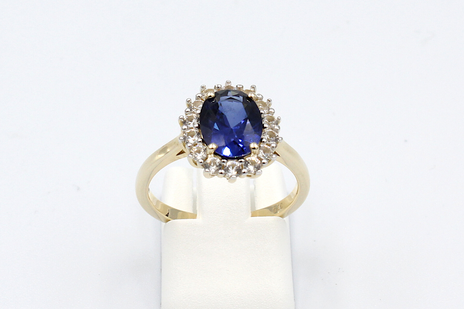 front view of a faux sapphire halo engagement ring