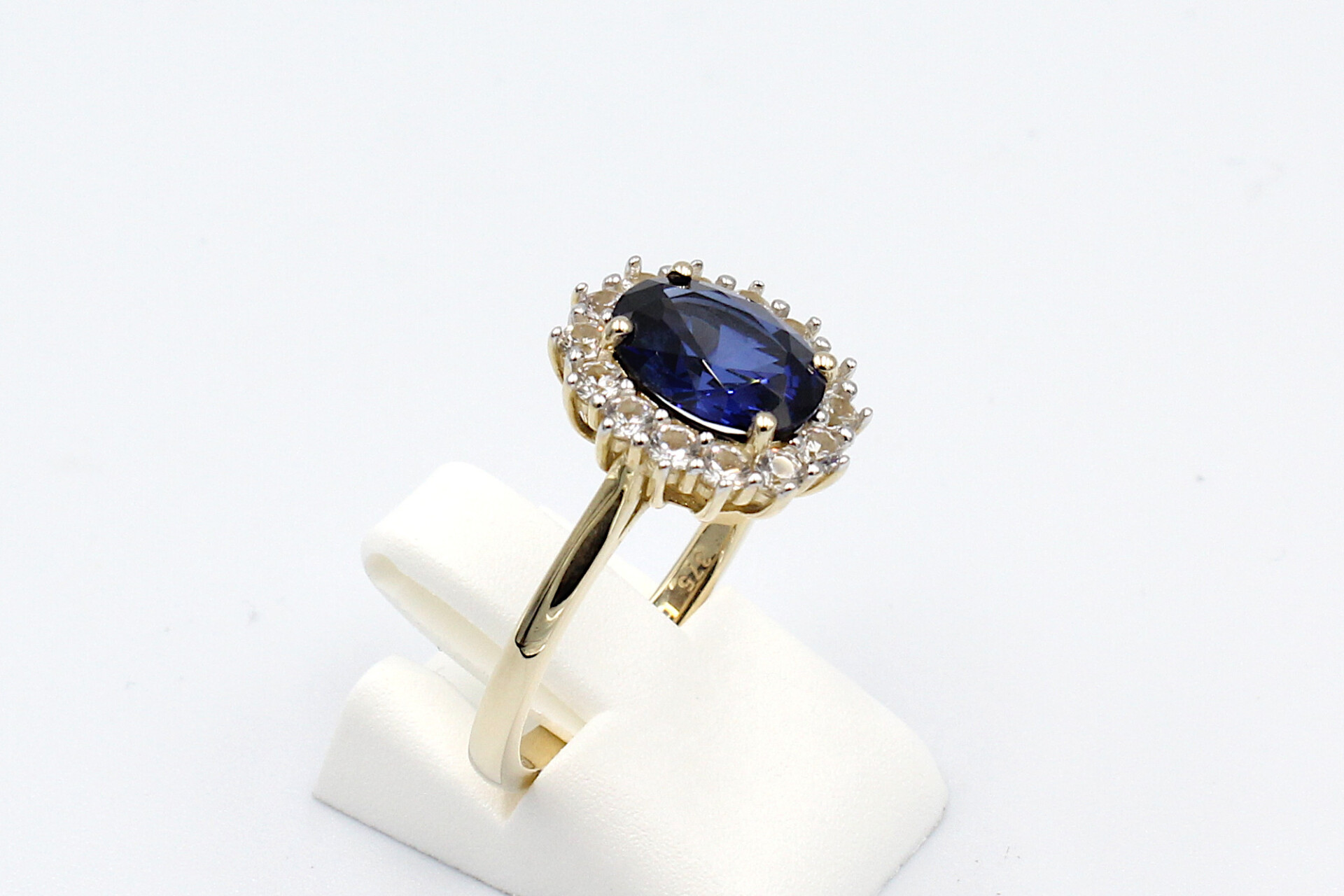 side view of a faux sapphire halo engagement ring