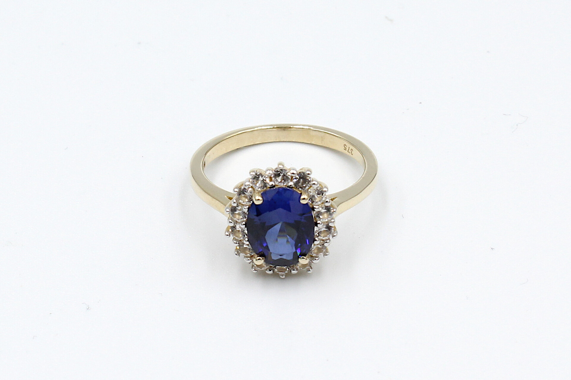 top view of a faux sapphire halo engagement ring