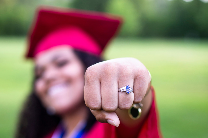 a graduation student showing off her class ring