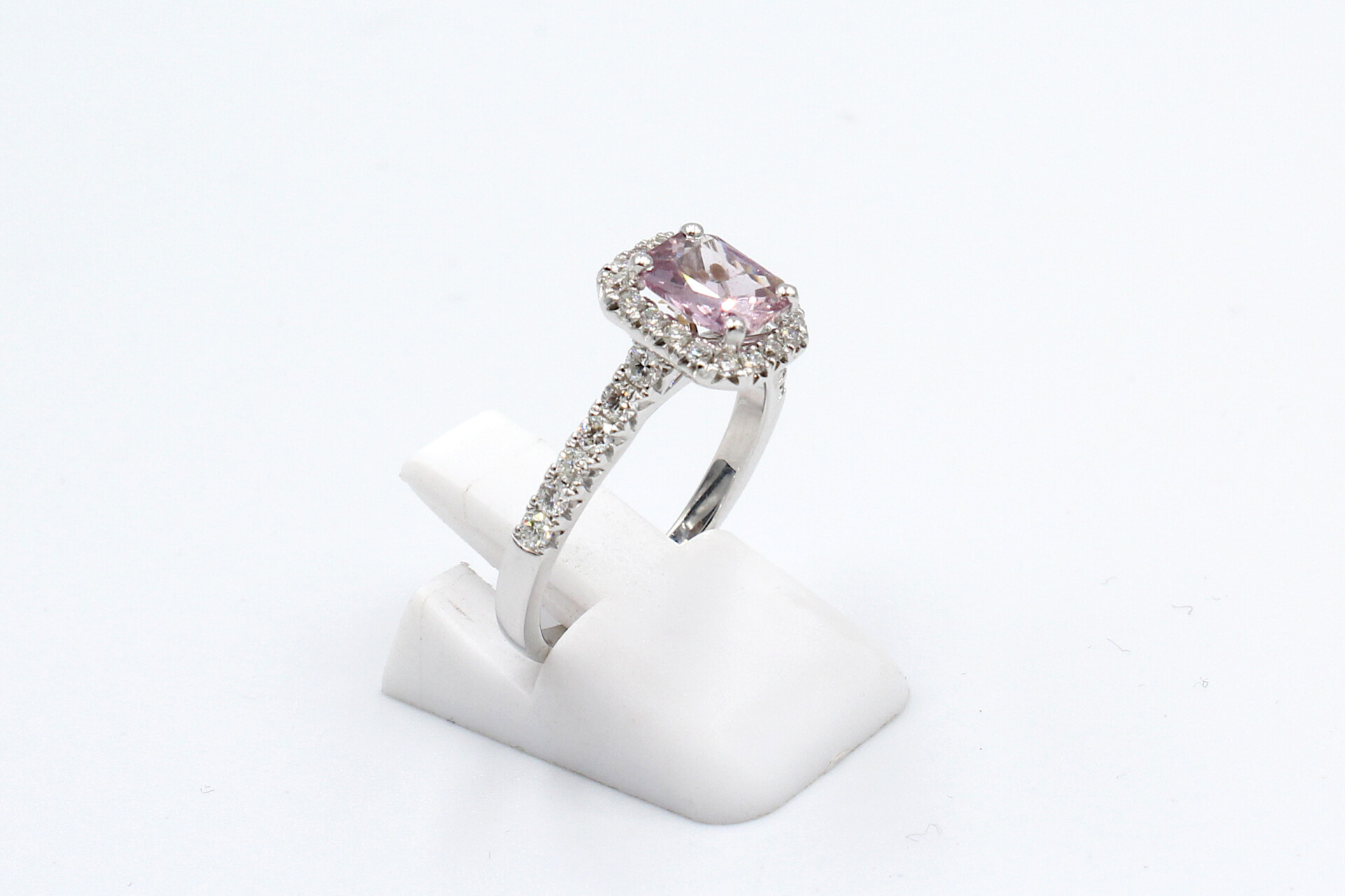 side view of a pink sapphire halo ring