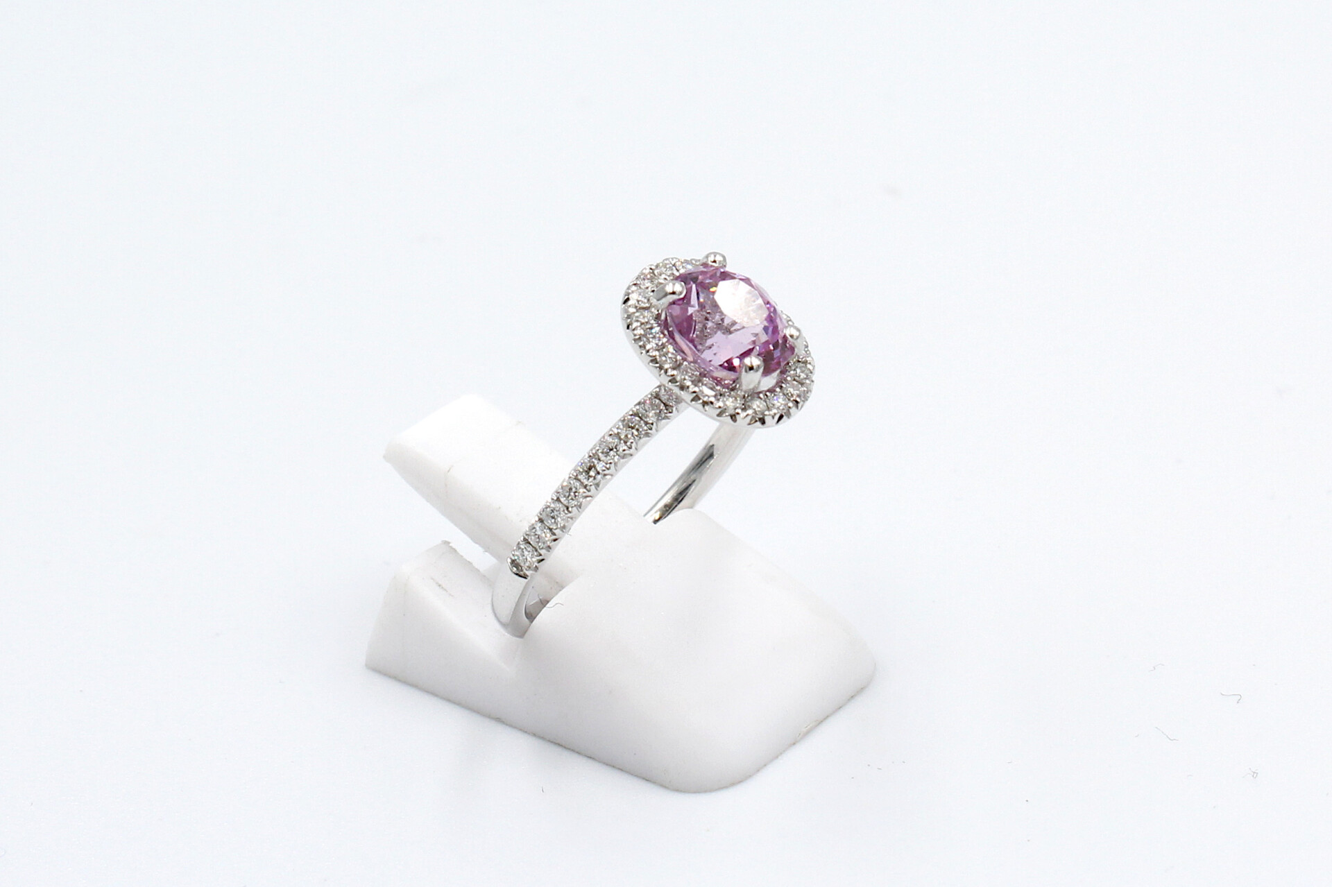 side view of a pink sapphire halo ring