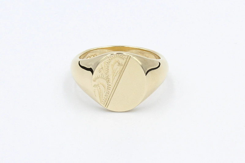 a gold signet ring with an engraved face