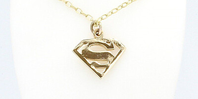 a handmade superman pendant