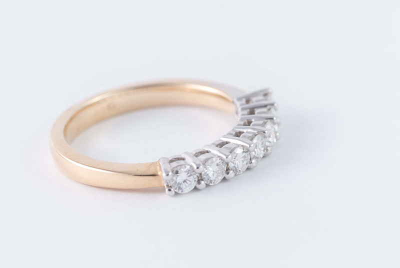 Decoding the Symbolism of Rings: 10 Iconic Rings and Their Stories gold anniversary ring set with a row of diamonds.