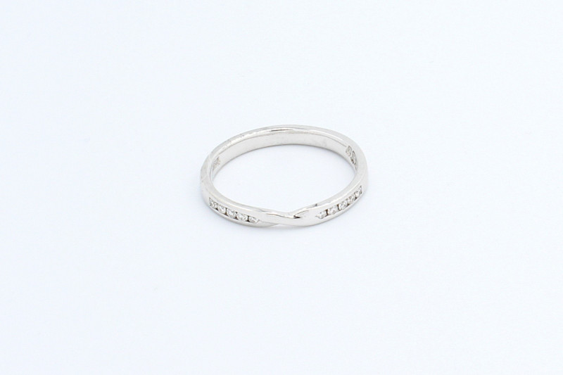 Decoding the Symbolism of Rings: 10 Iconic Rings and Their Stories white gold wedding ring with diamond set shoulders.