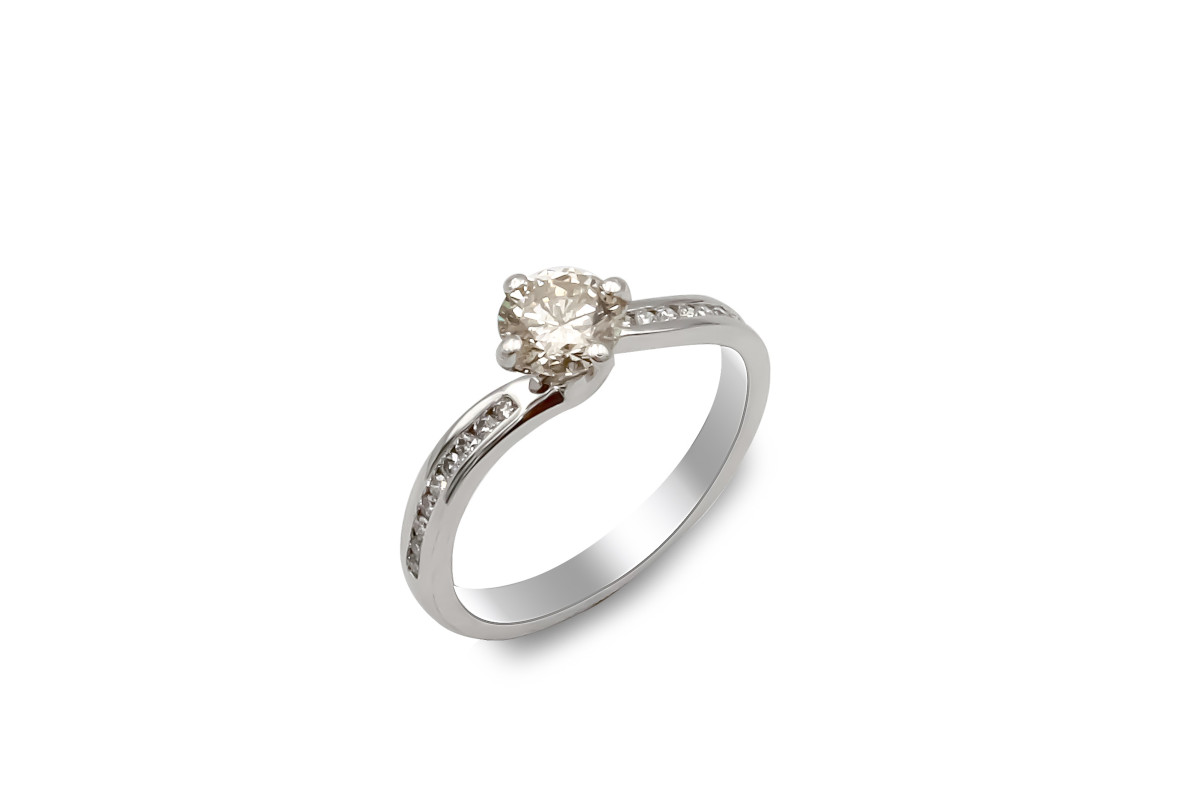 solitaire diamond ring with channel set shoulders made from platinum