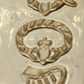 a gold claddagh symbol
