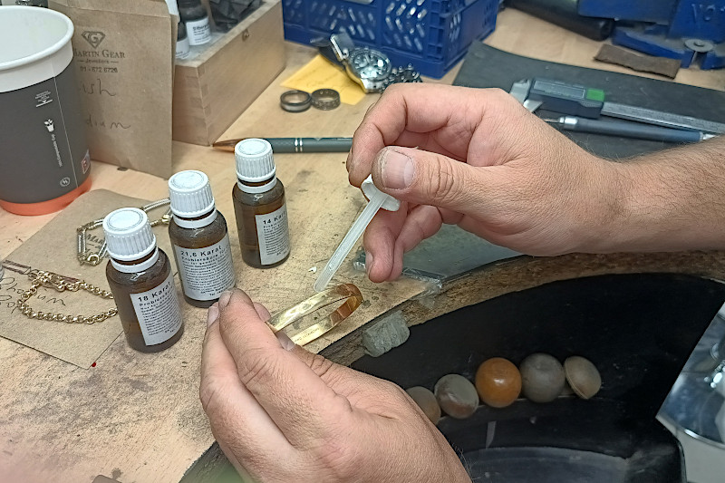 a jeweller testing gold jewellery