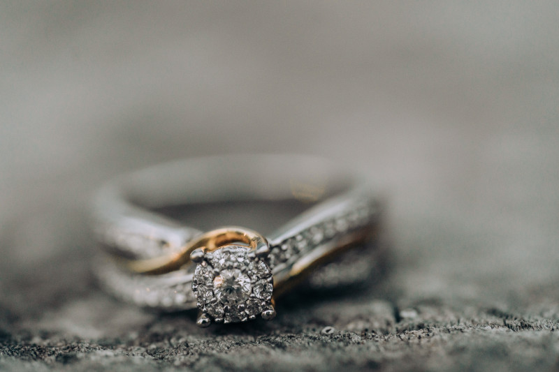 diamond and gold engagement ring with a blurred background